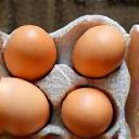 A crate of fresh, locally sourced brown eggs.